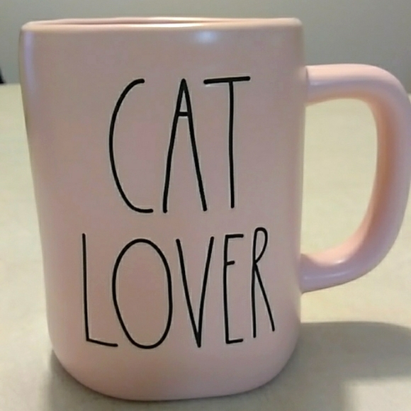 Rae Dunn cat lover coffee cup with stuffed kitty.